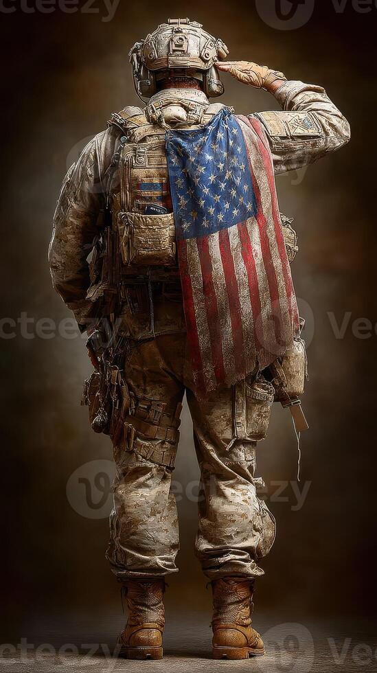 Soldier in tactical uniform saluting with American flag draped on back during dusk in a rugged setting photo