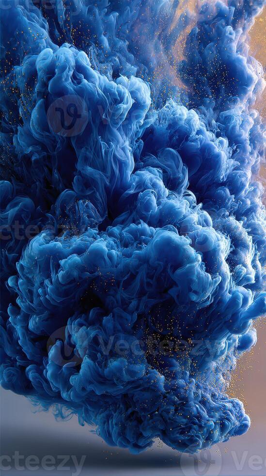 Swirling blue cloud with golden particles hovering in the air in a dramatic display of color and texture photo