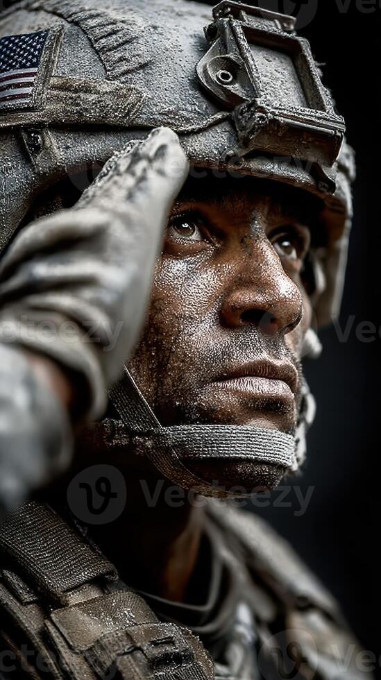 Soldier in combat gear saluting with determination during a military training exercise in a challenging environment photo