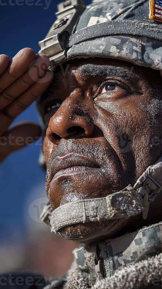 Saluting soldier in full uniform pays tribute under clear blue sky during military ceremony photo