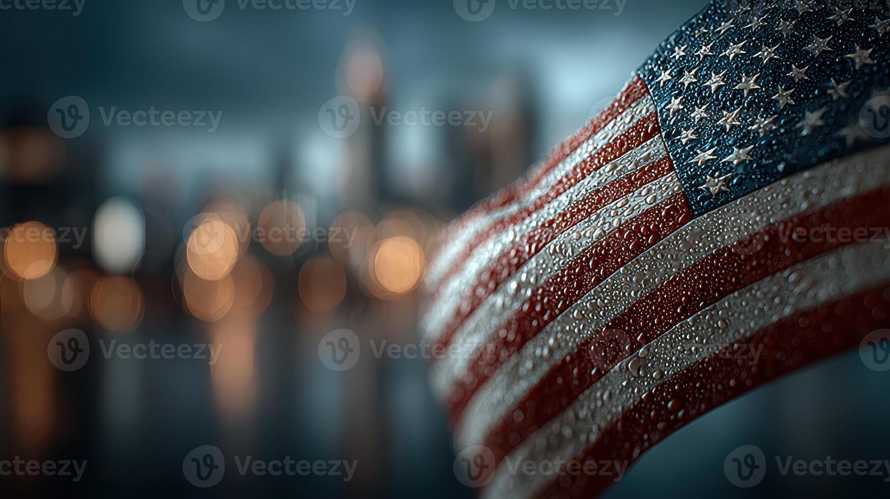American flag waves in the rain with blurred city skyline in the background during twilight hours photo