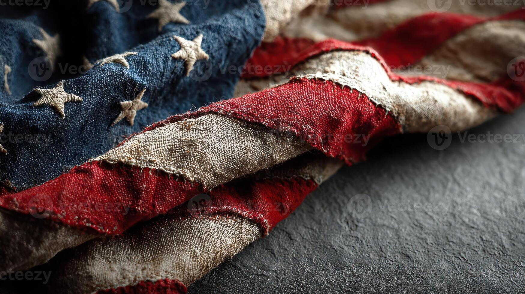 Worn American flag draped on a textured surface highlighting its historical significance and patriotic symbolism photo