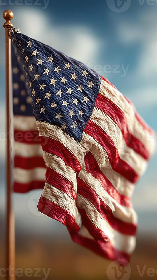 Waving American flag against a blue sky with clouds in the background during a sunny day photo