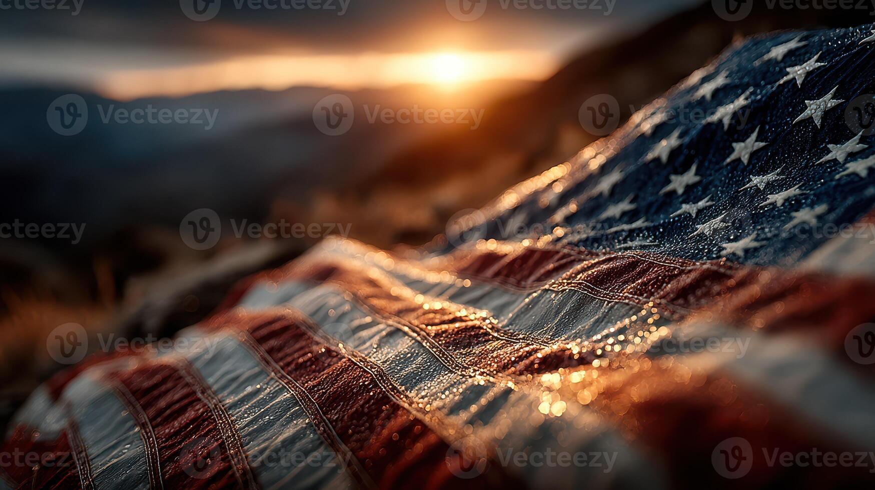 Dewy American flag resting on the ground during sunset with soft sunlight illuminating the fabric and surrounding landscape photo