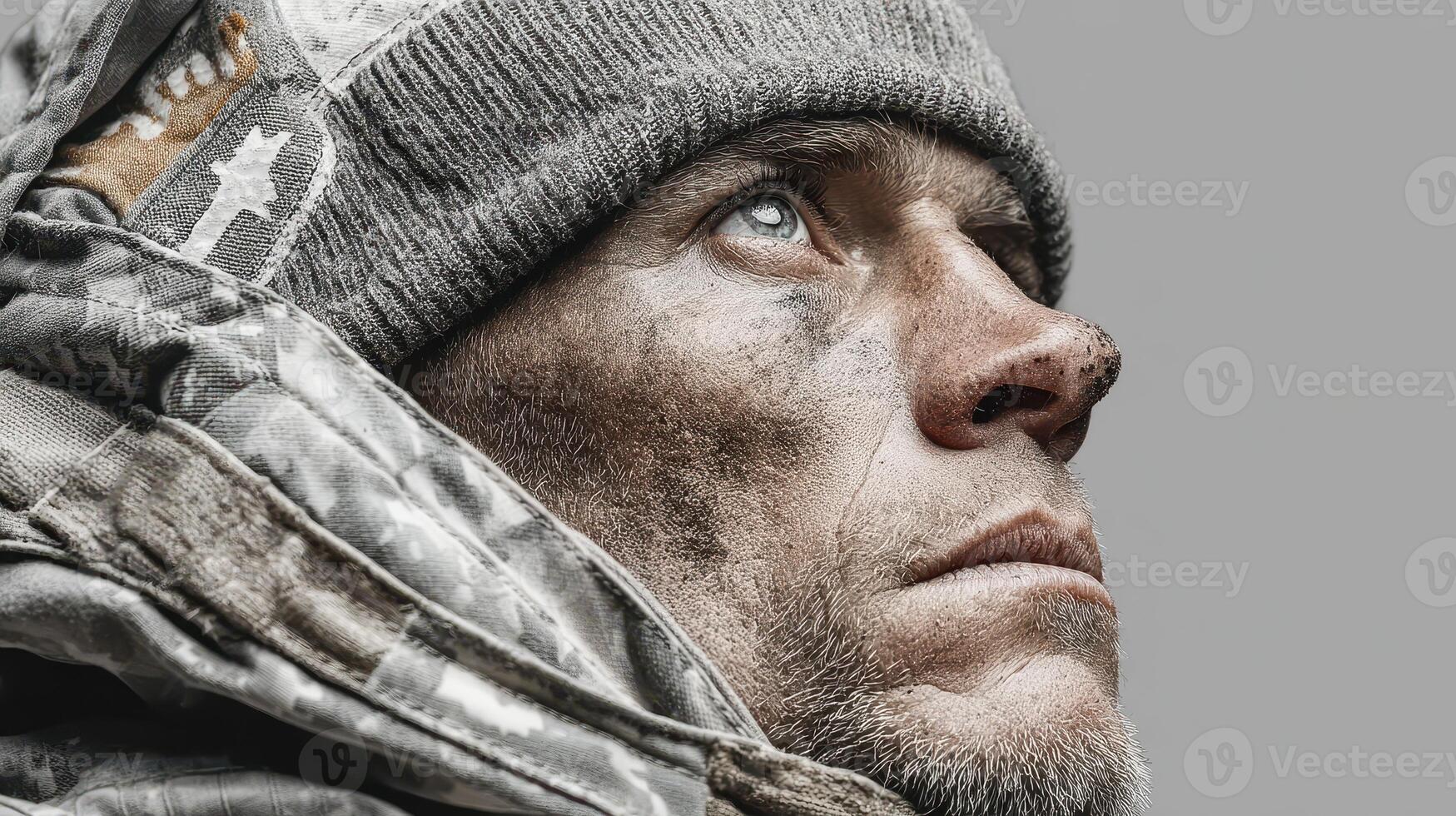 Portrait of a rugged man wearing a hat with a determined expression set against a neutral background photo