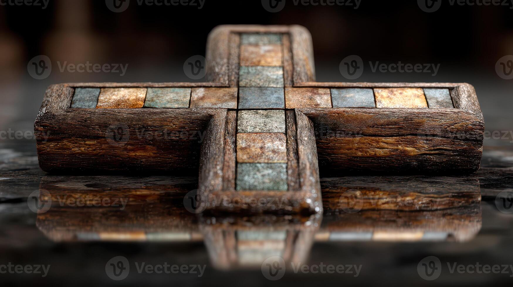 Decorative wooden cross with stone inlays displayed on a dark reflective surface in a serene setting photo