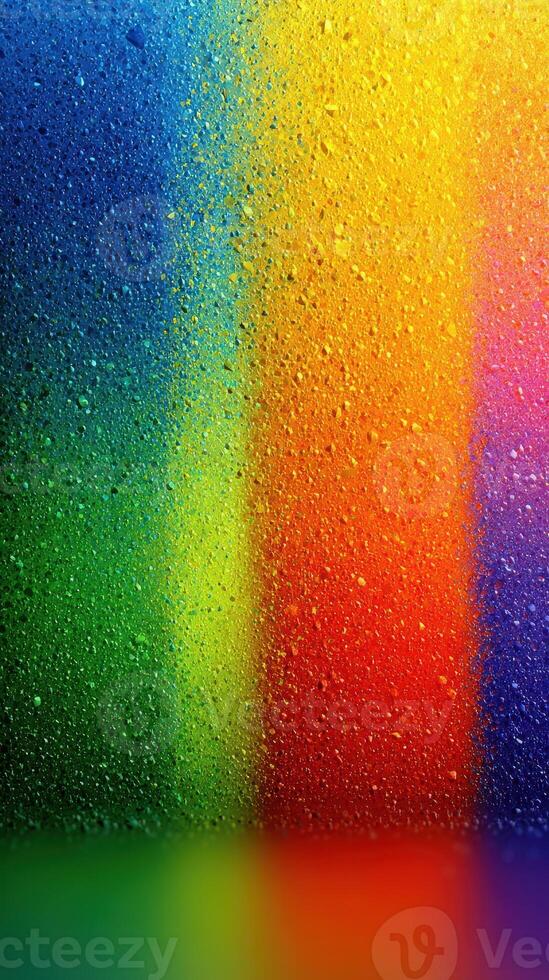 Vibrant colors blending with droplets of water on a glass surface create a stunning abstract view photo