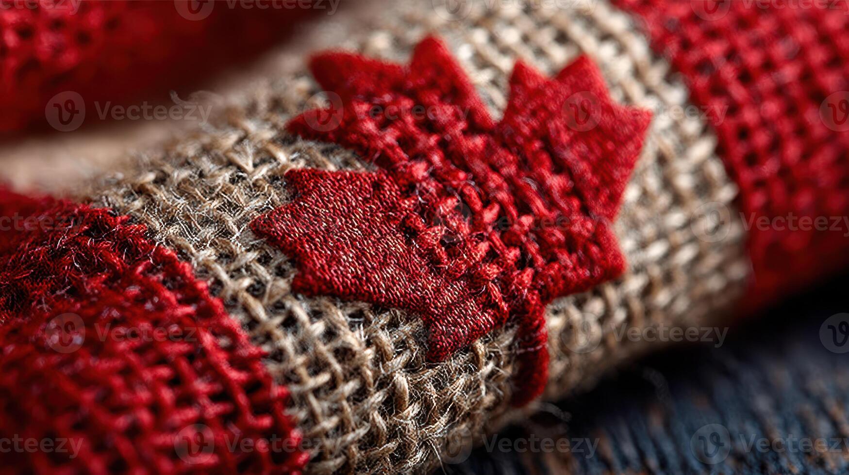 Red and beige woven fabric featuring a Canadian maple leaf design in intricate detail and texture on a close-up shot photo