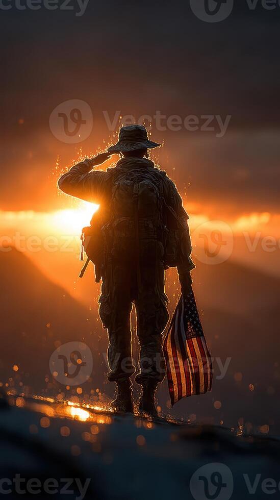 Soldier saluting at sunset with American flag during a moment of reflection in a mountainous landscape photo