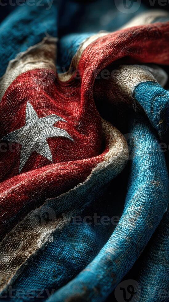 Worn Cuban flag displaying its rich colors and textures in a close-up view highlighting its history and significance photo