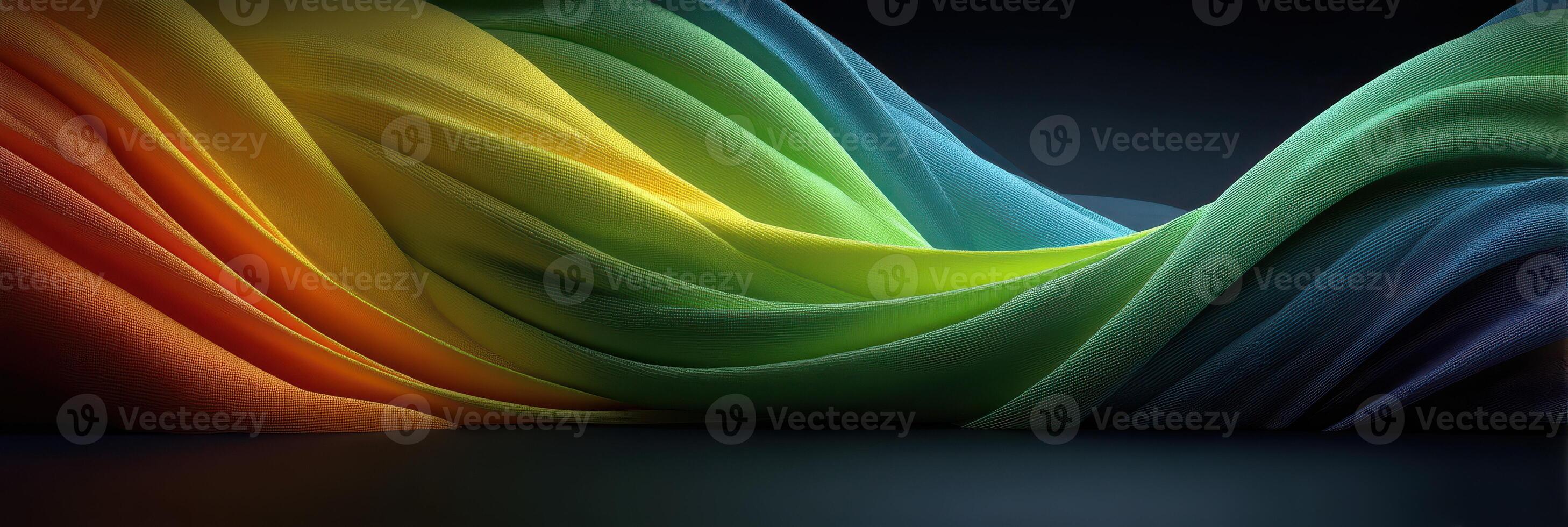 Colorful fabric waves create a flowing abstract design in a dark environment, bringing vibrancy and depth to the composition photo