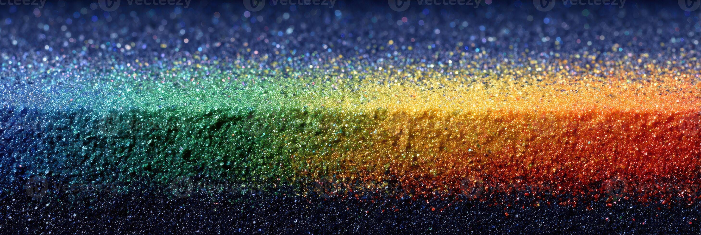 Vibrant rainbow spectrum of glittery particles creating a striking visual display across a dark background photo