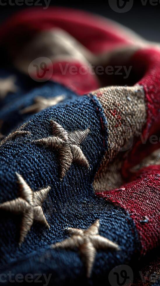 Vintage American flag draped with intricate stitching, showcasing its rich details and textures in muted lighting photo