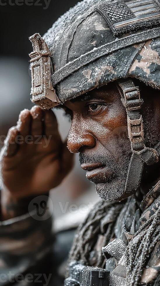 Soldier saluting in winter conditions with frost on uniform during a military ceremony in an outdoor setting photo