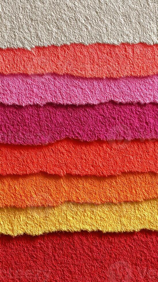 Colorful textured paper layers arranged in a vibrant display showcasing various shades of red, pink, and orange photo