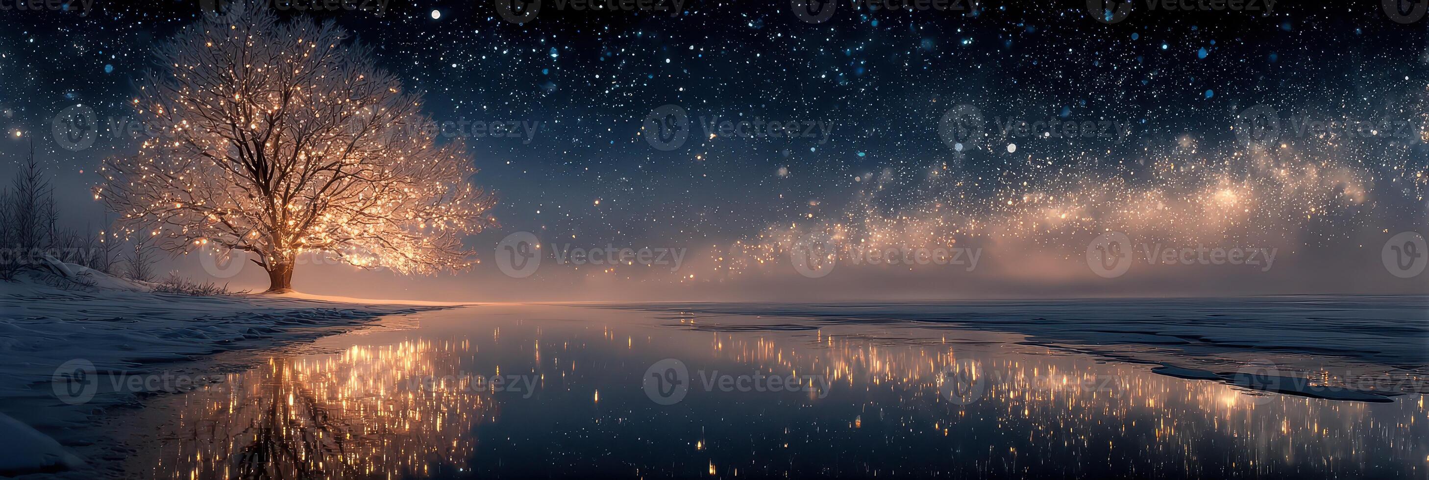 Bright tree illuminates snowy landscape under starry sky at night near a calm water surface in winter wonderland photo