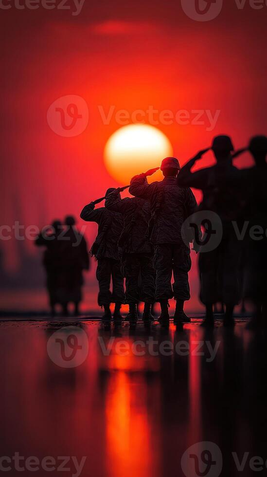 Soldiers saluting at sunset along the shoreline during an evening ceremony in a peaceful setting photo