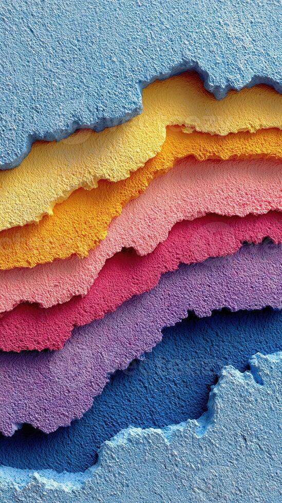 Colorful layers of textured wall paint peeling in various shades during daylight hours photo