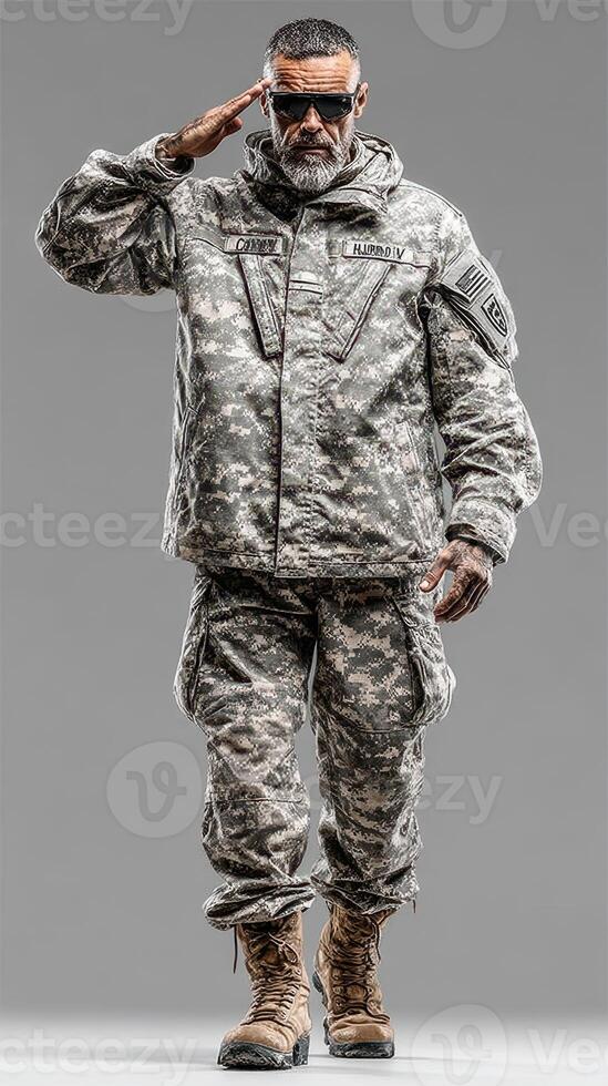 Soldier in military uniform saluting with confidence in a neutral gray background setting photo