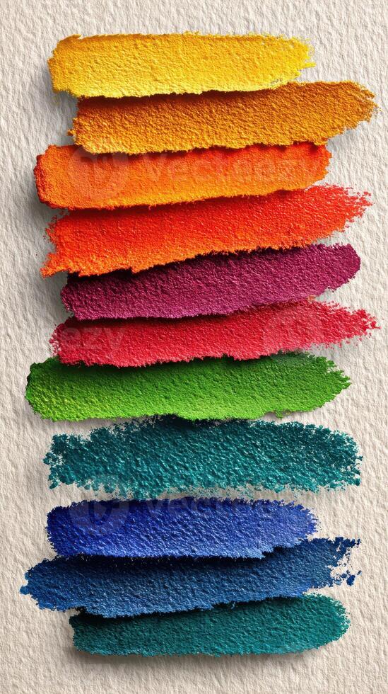 Vibrant paint strokes arranged in colorful layers showcasing various shades on textured background photo