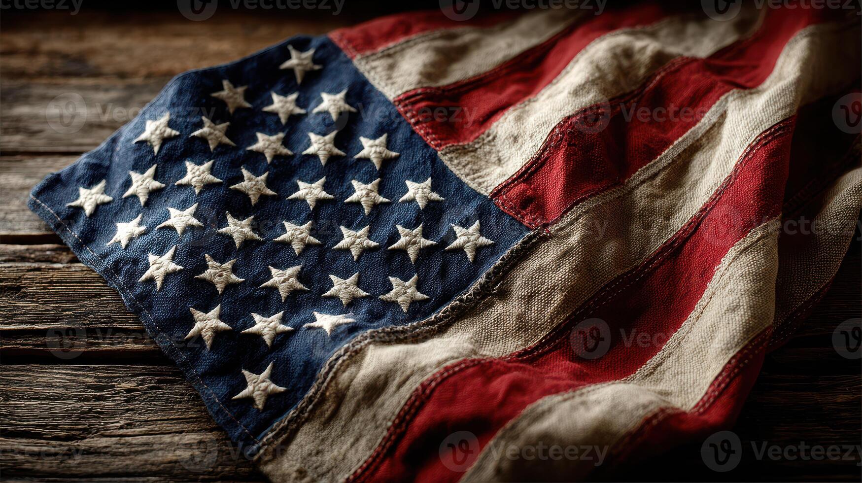 Worn American flag resting on rustic wooden surface, showcasing its rich colors and details photo