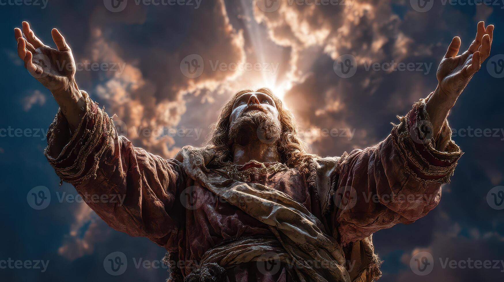 Statue of a religious figure with outstretched arms against a dramatic sky at dusk photo