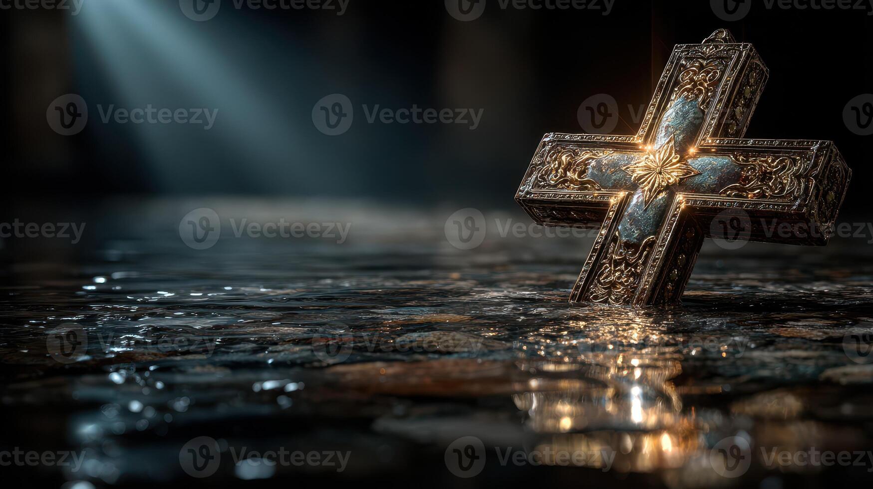 Cross illuminated in reflective water with soft light highlighting ornate details in a darkened environment photo