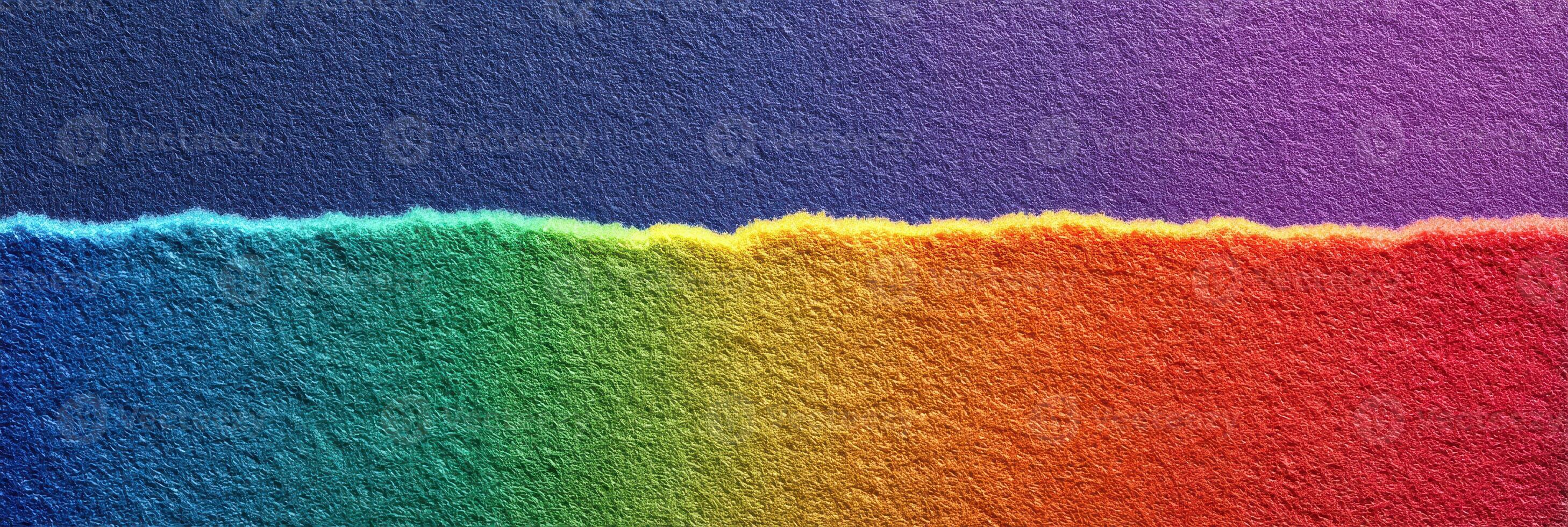 Brightly colored torn paper displaying a rainbow gradient with a textured background photo