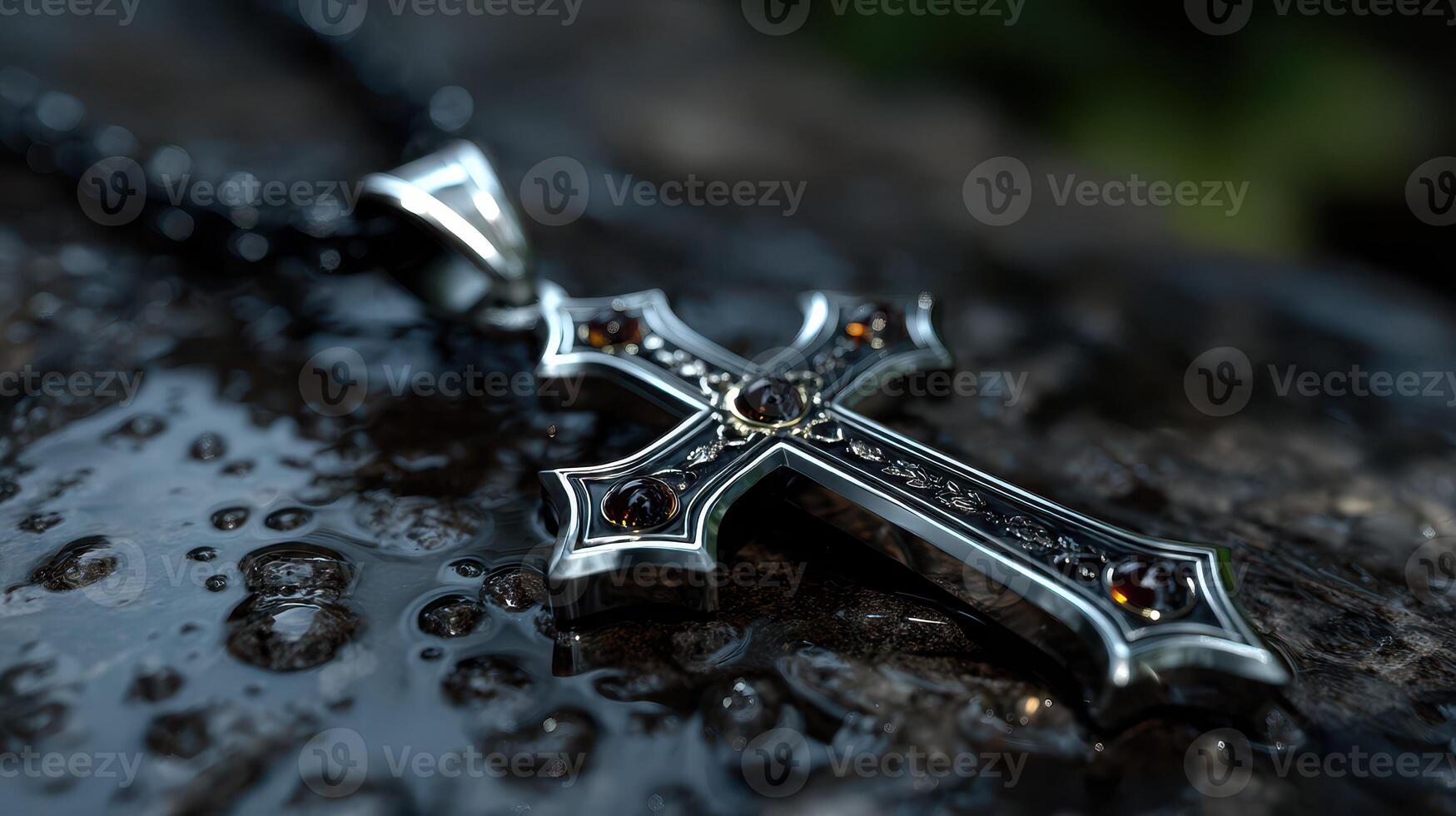 Jewelry resting on wet stone surface with intricate cross design sparkling in natural light photo