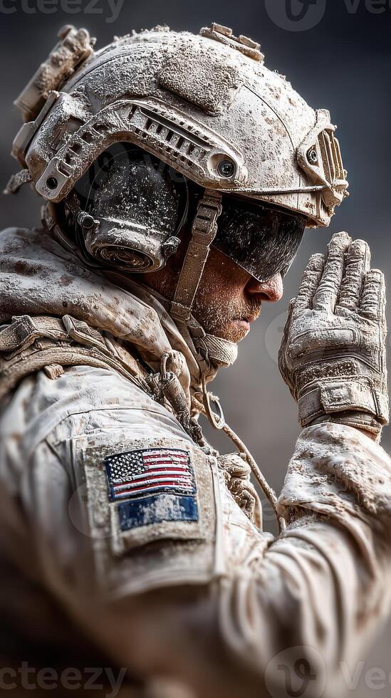 Military soldier in desert attire praying during a mission at dusk in an arid landscape photo