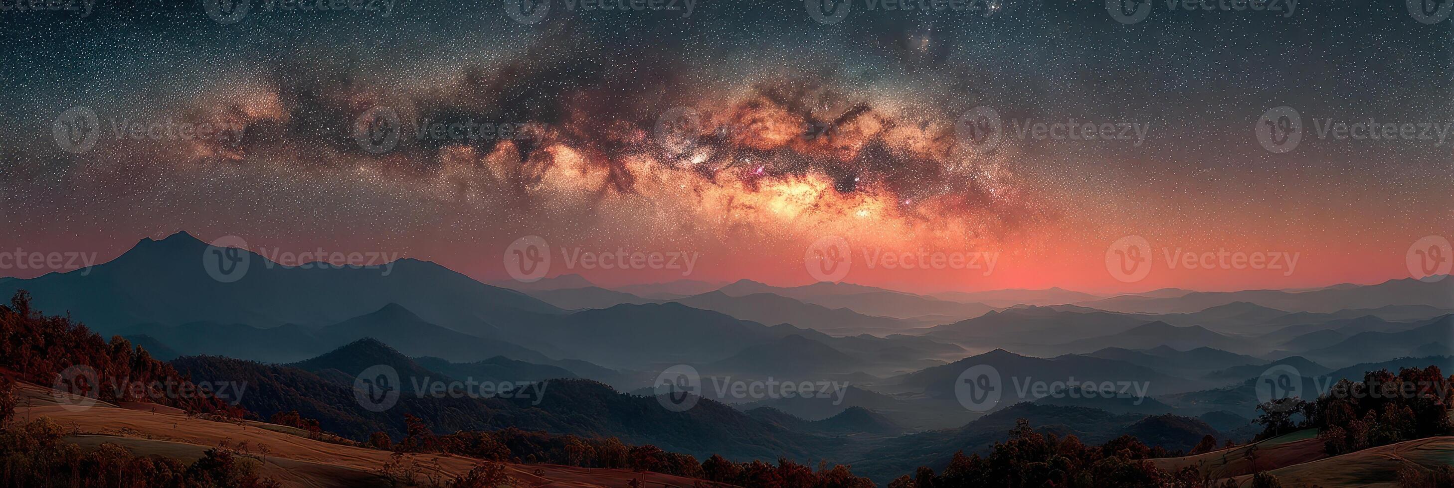 Stunning panorama of the Milky Way over mountain range during twilight in serene wilderness photo
