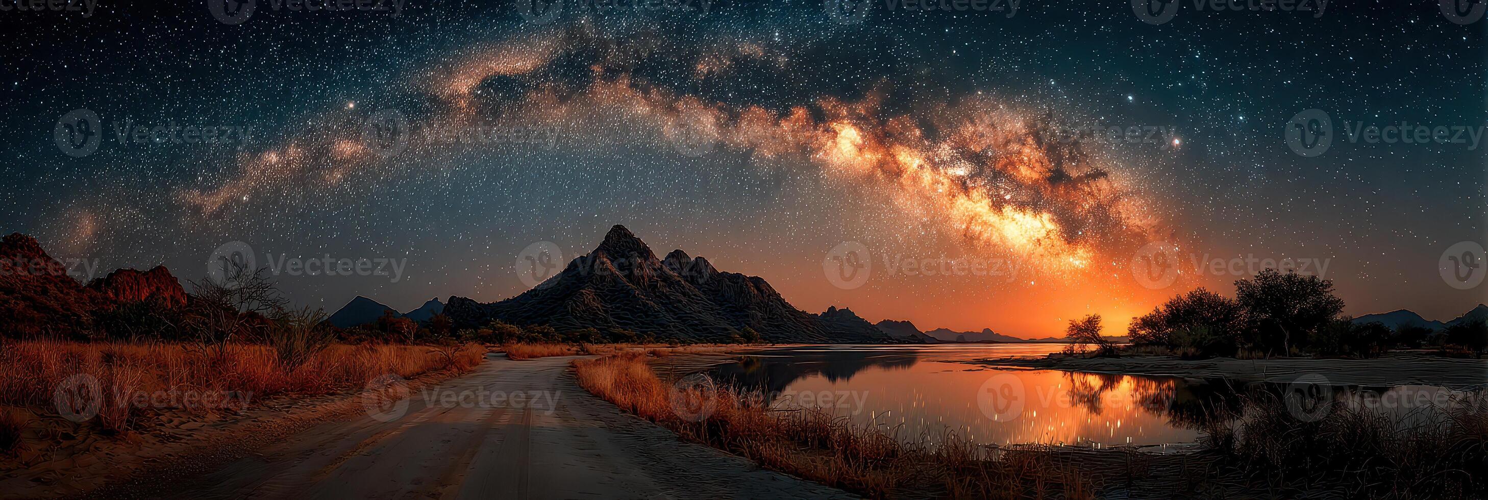 Majestic Milky Way shining over a calm lake and rocky mountains at dusk in a desert landscape photo
