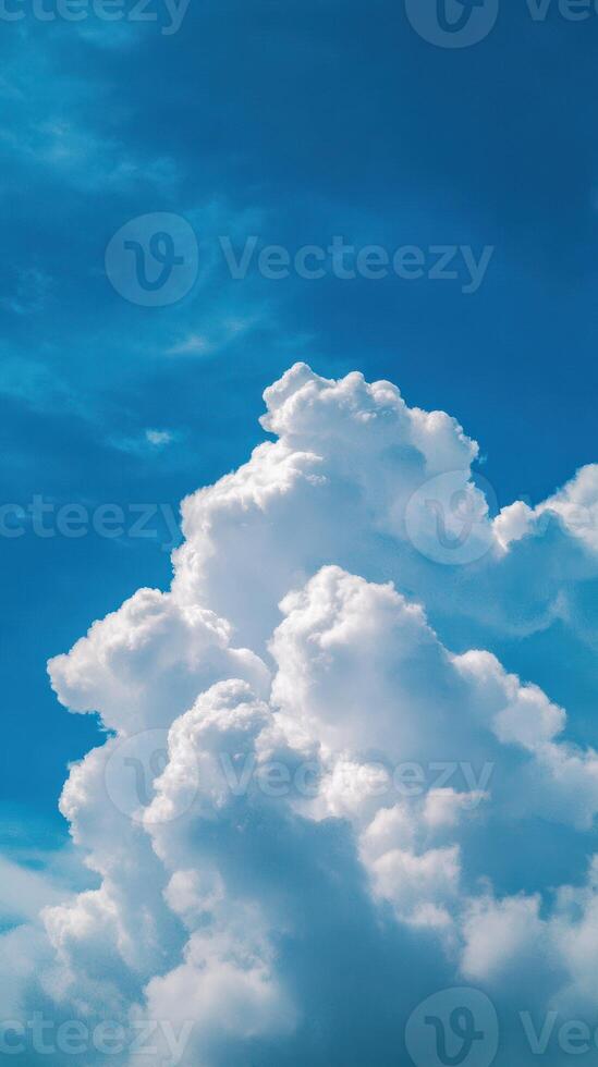 White fluffy clouds gather in the bright blue sky during a sunny afternoon photo