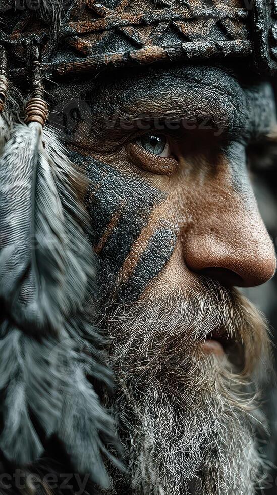 Portrait of a tribal warrior with painted face and feathers in a forest setting during daylight photo