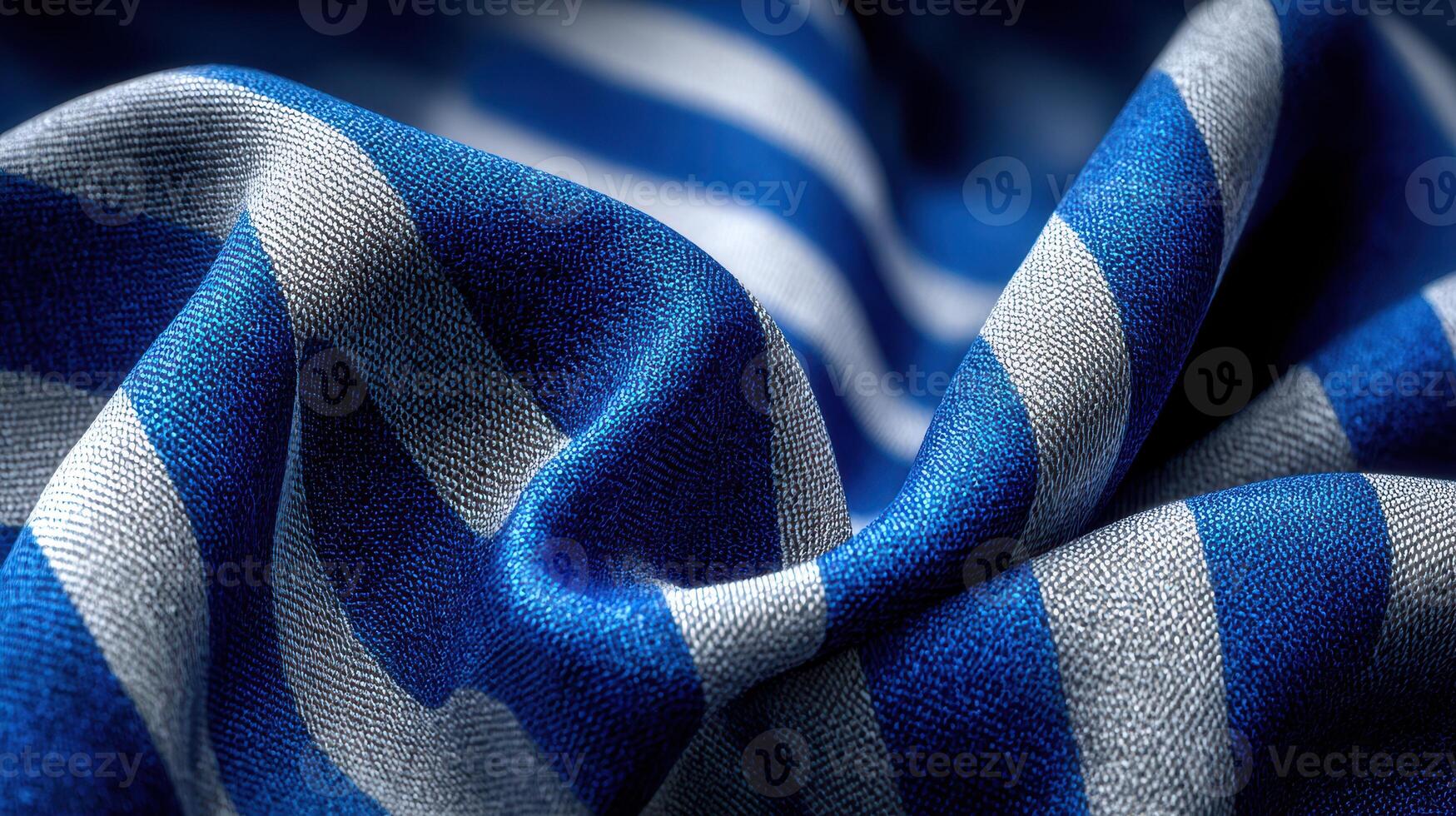 Colorful striped fabric drapes elegantly showcasing blue and white patterns in a soft texture photo