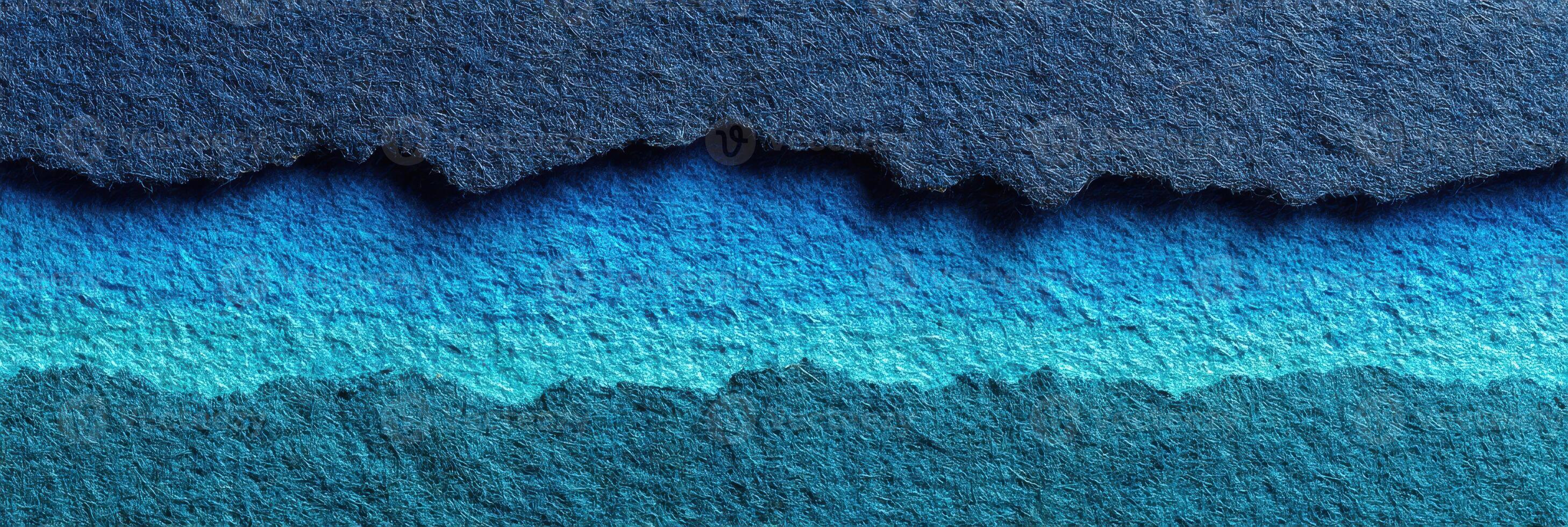 Colorful torn paper edges create a layered ocean effect with shades of blue in a creative artwork photo