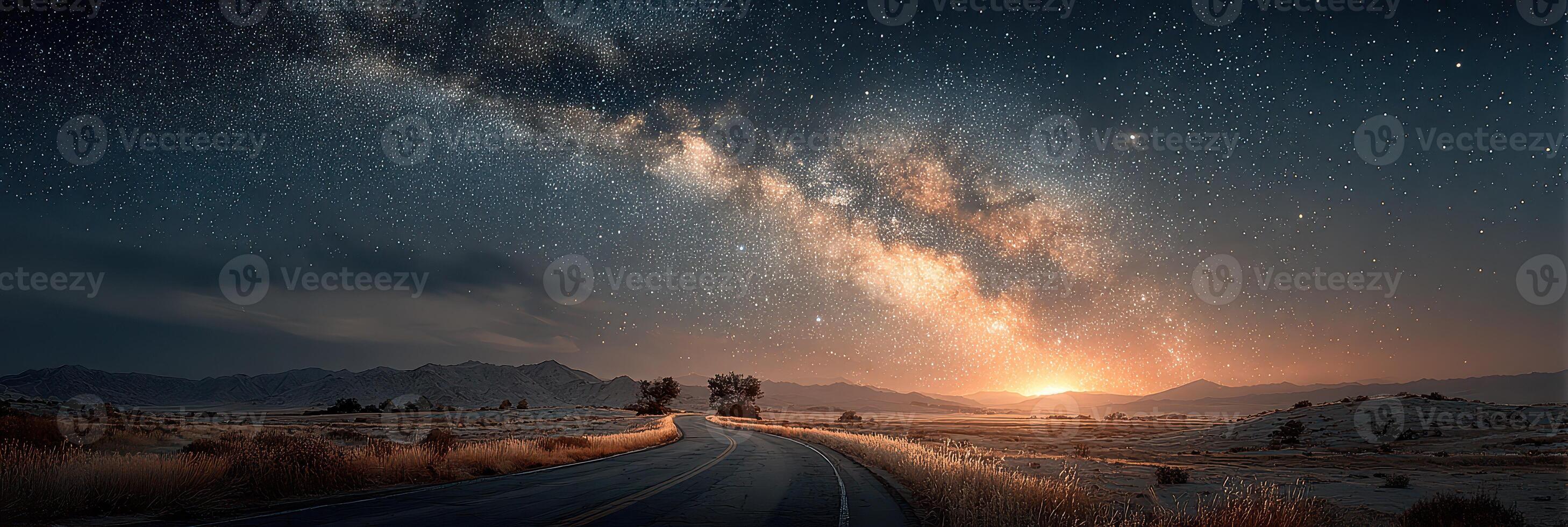 Milky Way illuminates a winding road beneath a starlit sky in a serene desert landscape at dusk photo