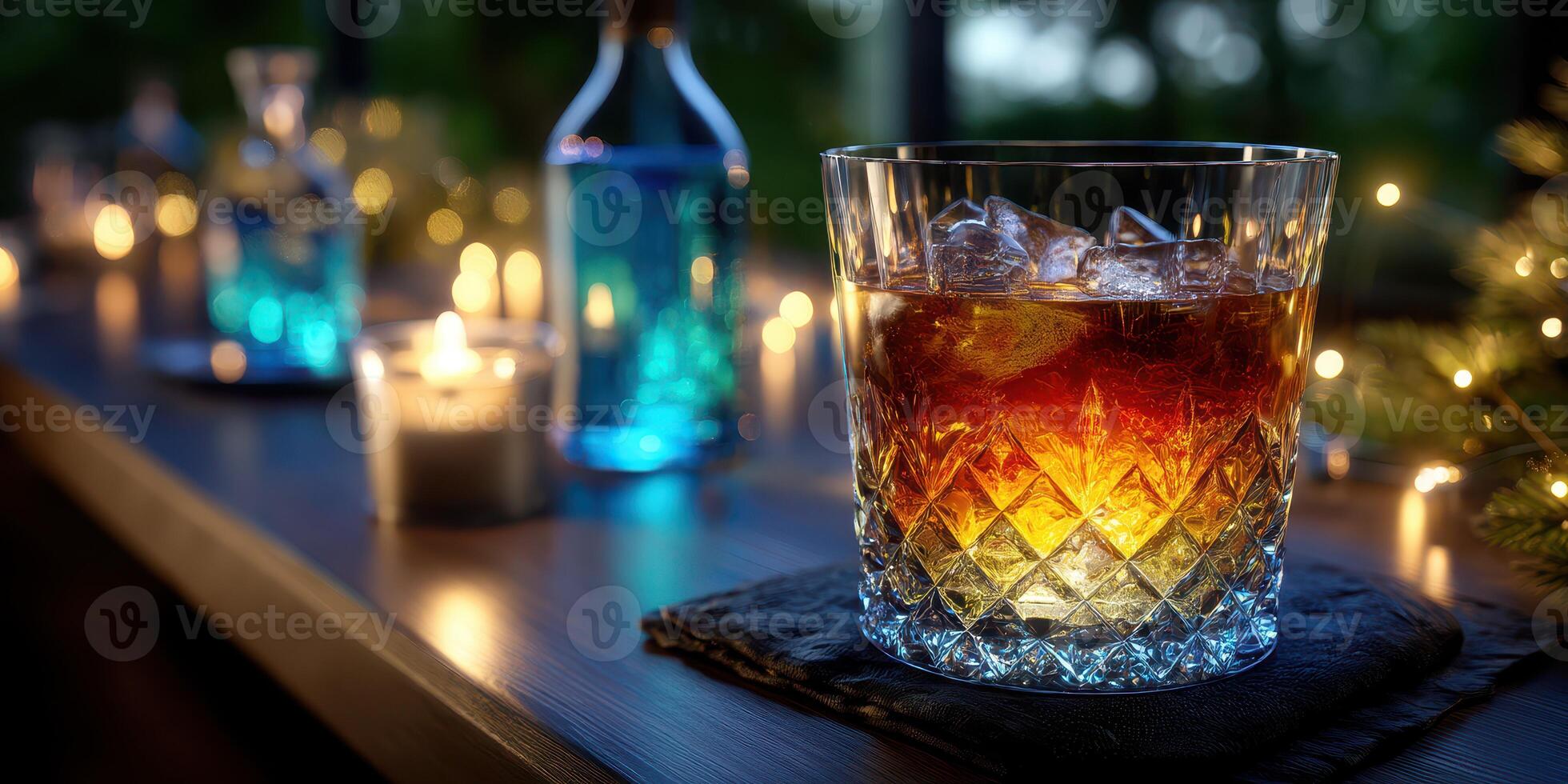 Elegant glass of whiskey on a wooden bar surrounded by lit candles and colorful bottles during an evening setting photo