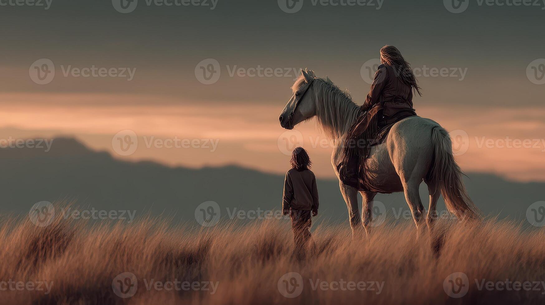 A rider on a white horse stands beside a child against a beautiful sunset landscape with mountains in the background photo