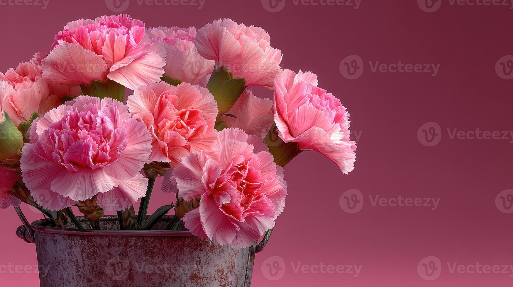 Pink carnations arranged in a rustic metal bucket against a soft pink background photo