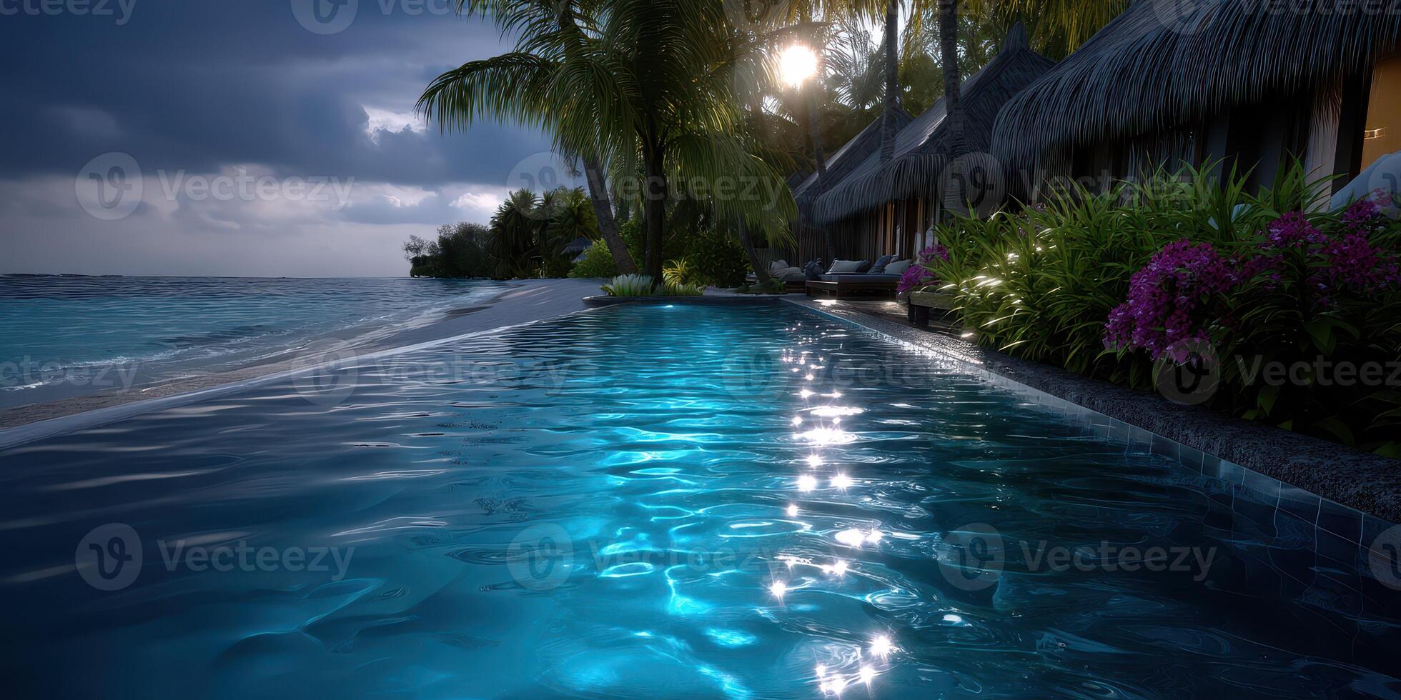 Tranquil evening by the ocean with illuminated pool and tropical surroundings at a beachfront resort photo