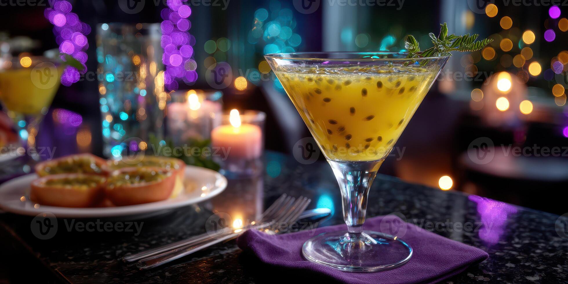 Colorful passion fruit cocktail served in a stylish bar with soft lighting and a delightful snack on the table photo