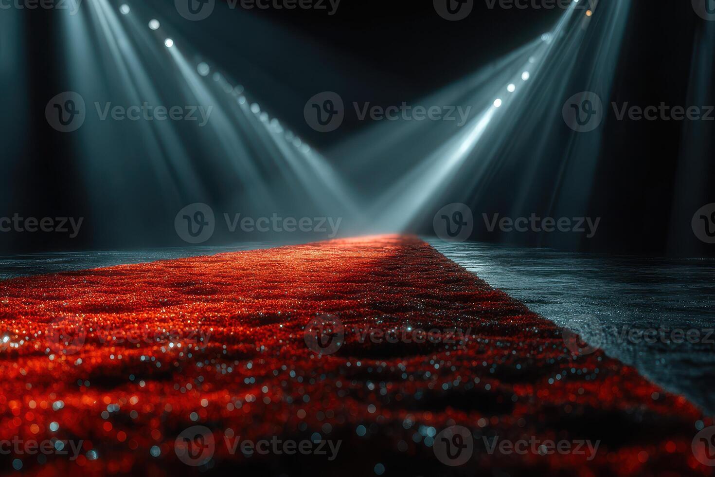 Red carpet leading to a spotlight stage with dramatic lighting effects in a dimly lit venue photo