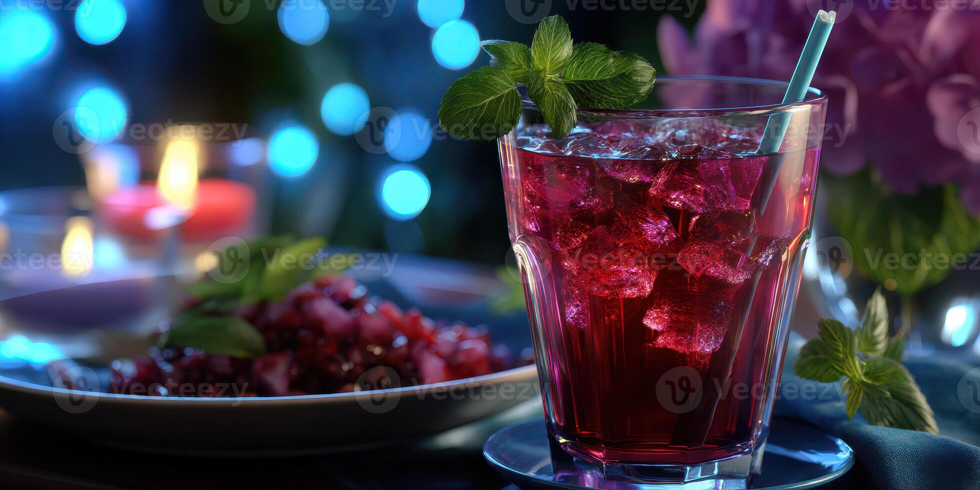 Refreshing cocktail with ice and mint served at an evening gathering amidst soft glowing lights photo