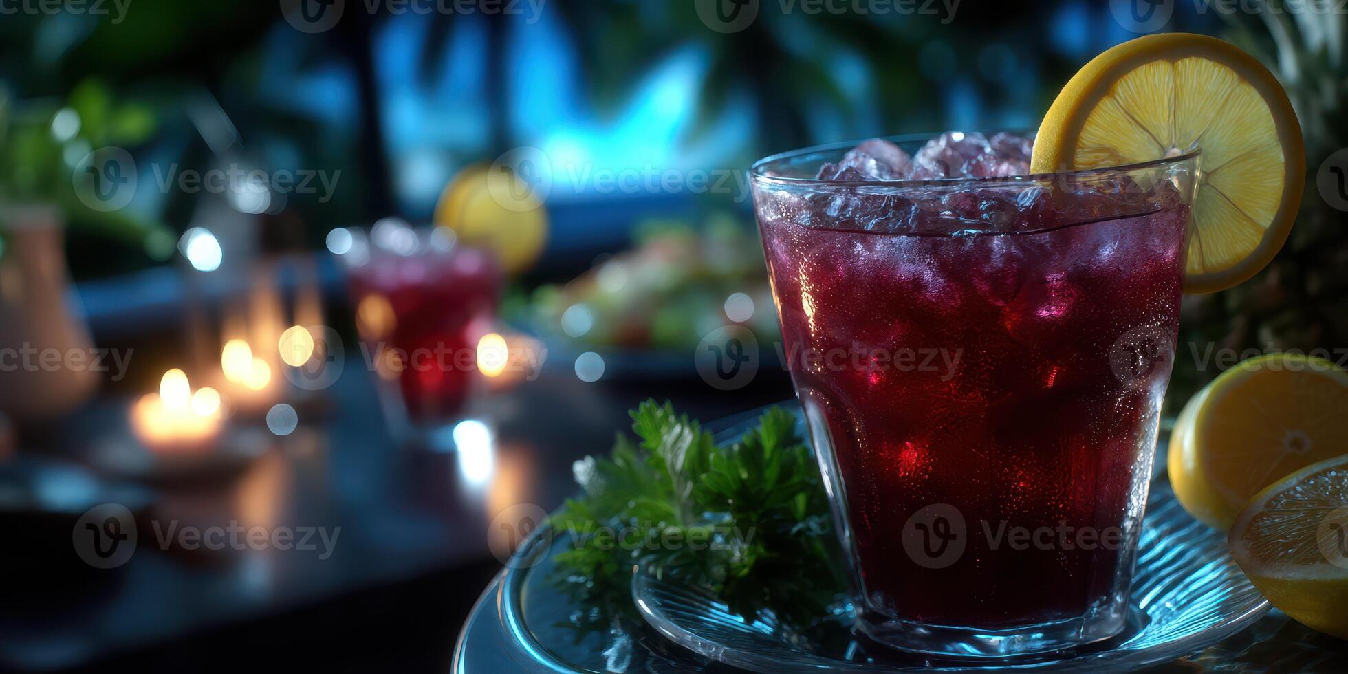Vibrant drink with lemon slice served at a tropical dinner party during an evening gathering photo
