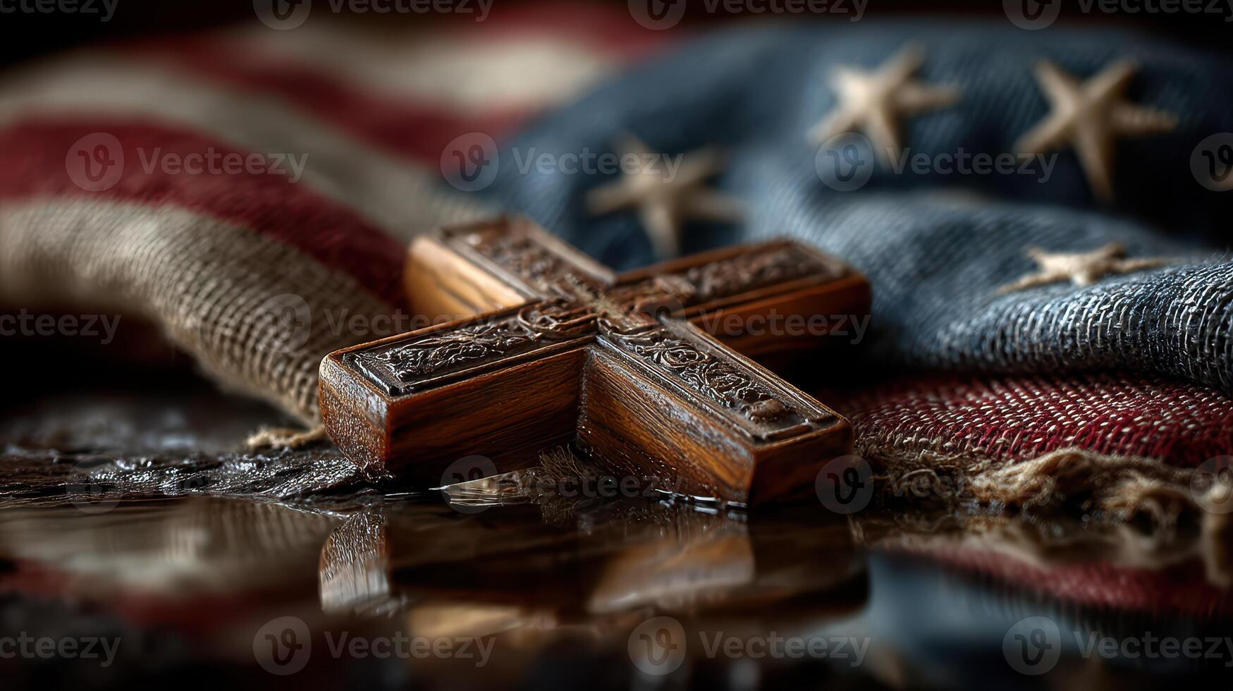 Cross resting on folded American flag representing faith and patriotism in a solemn setting photo