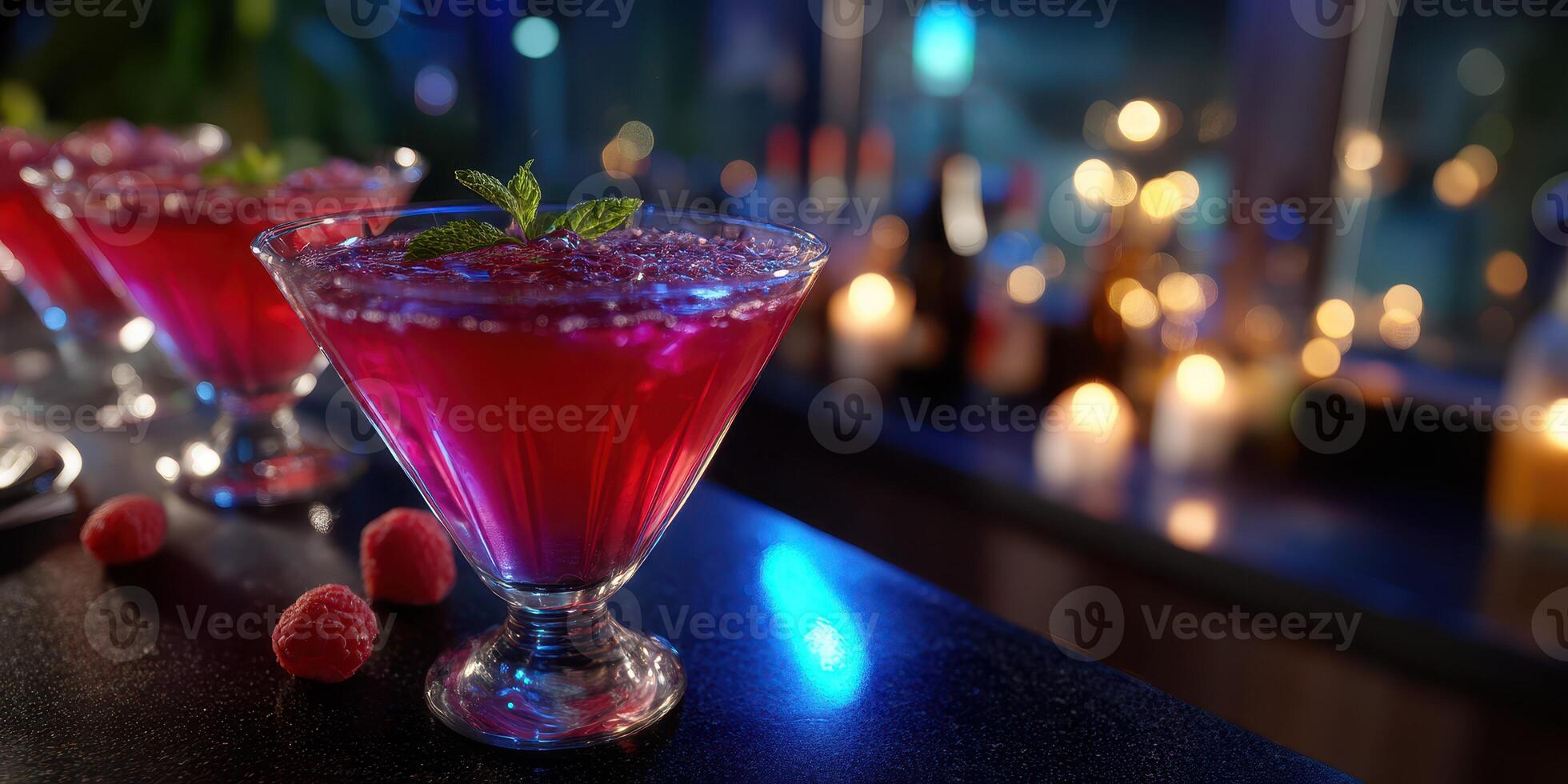 Vibrant cocktails with fresh raspberries served in a chic bar setting at night photo
