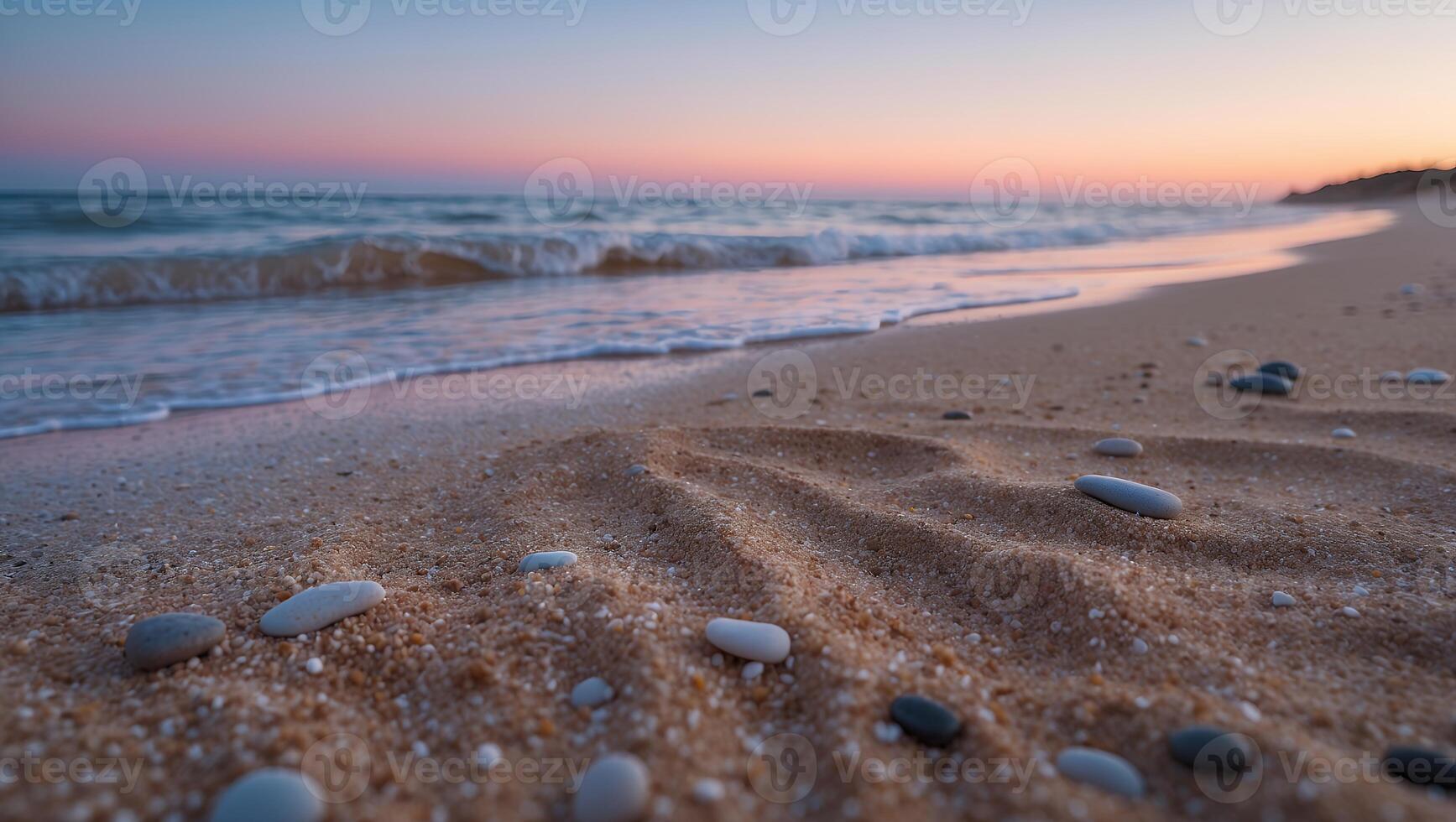 Stones on Sandy Beach at Sunset with Soft Waves and Colors photo