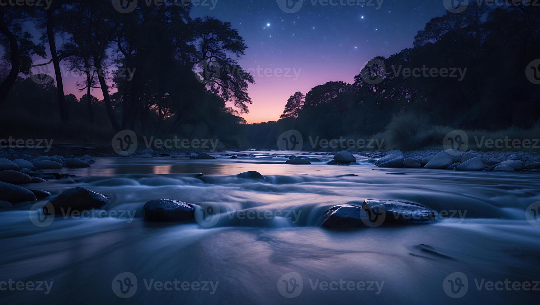 River Flowing Through Forest at Dusk Under Starry Night Sky photo