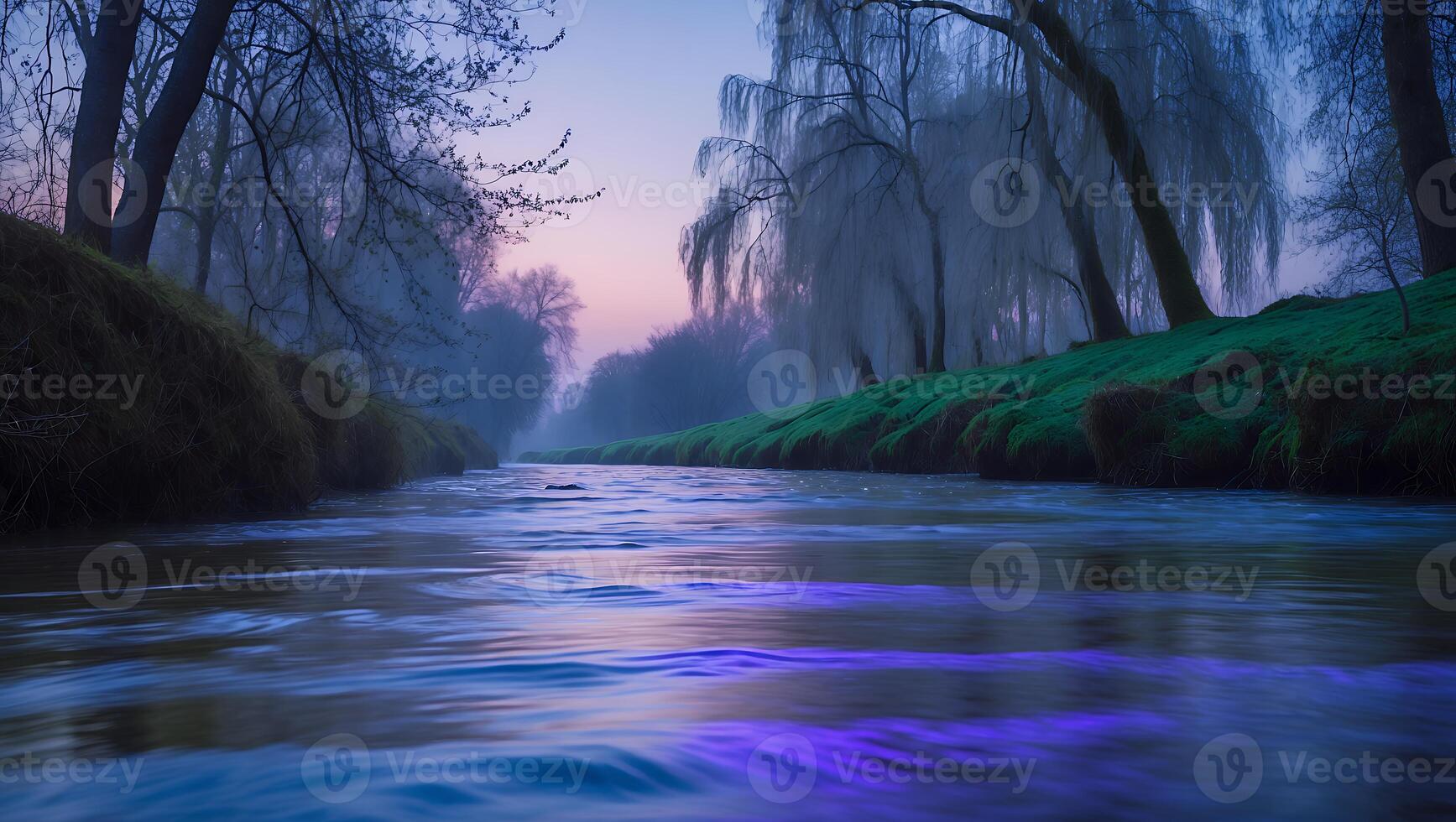 Flowing River Through Foggy Landscape with Trees and Colorful Sky photo